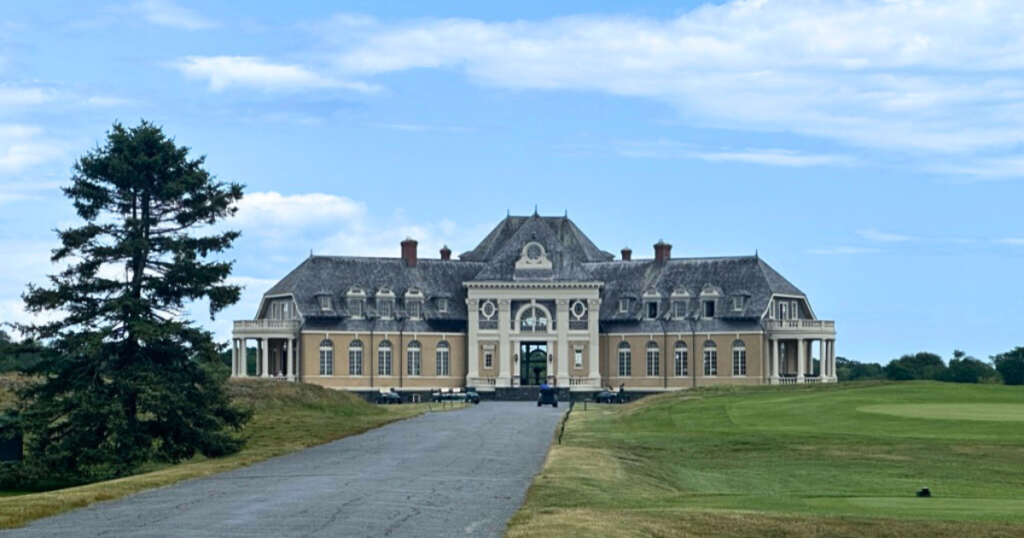 Newport Country Club in Newport, Rhode Island. Entryway and main building to the course are at the end of a long driveway.